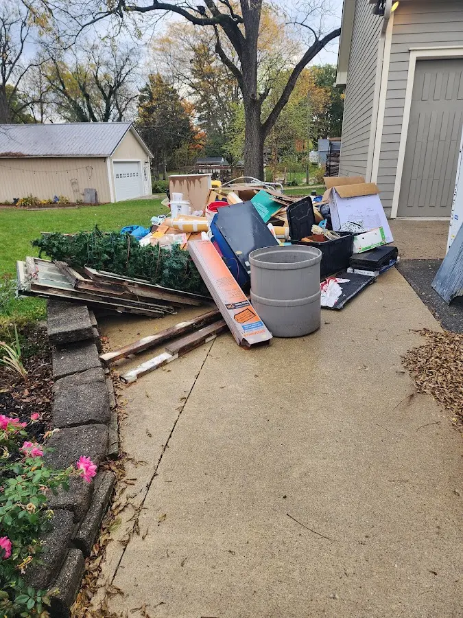 Dumpster being loaded with debris for Estate Cleanout Dumpster Rental in Corbin